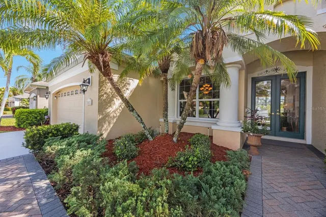 a view of a house with a small yard and plants