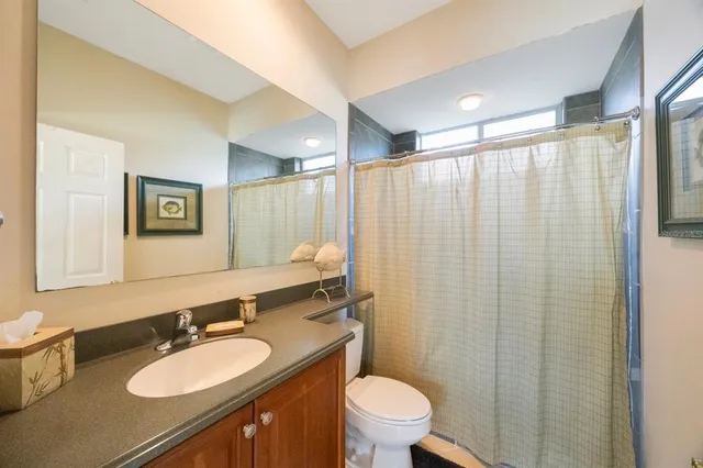 a living room with furniture ceiling fan and a window