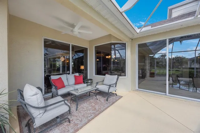 a dining room with furniture and a floor to ceiling window