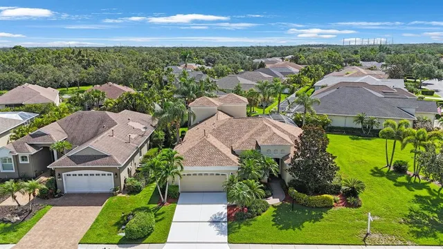 an aerial view of residential houses with outdoor space and swimming pool