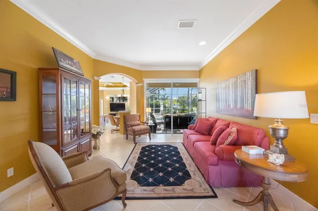 a living room with furniture and a floor to ceiling window
