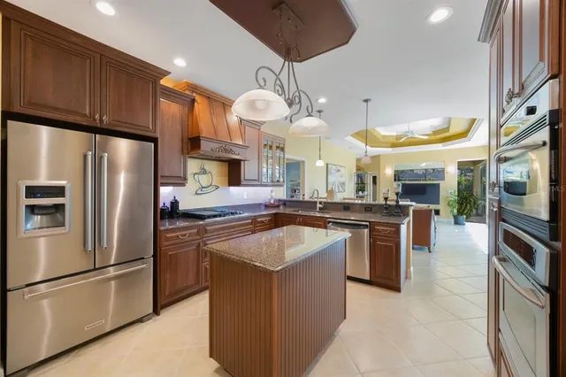 a kitchen with stainless steel appliances granite countertop a sink stove and cabinets