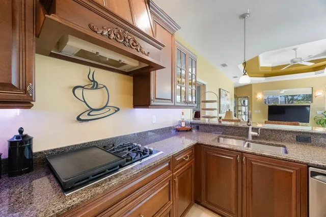 a large kitchen with stainless steel appliances granite countertop a stove and a refrigerator
