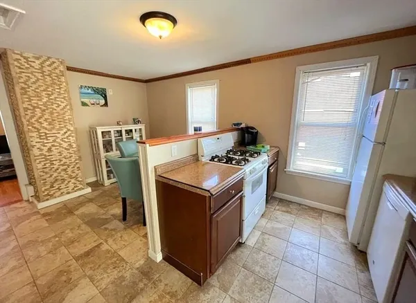 a kitchen with granite countertop a sink stove and refrigerator