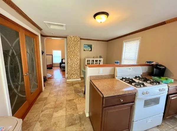 a kitchen that has a stove and a table in it