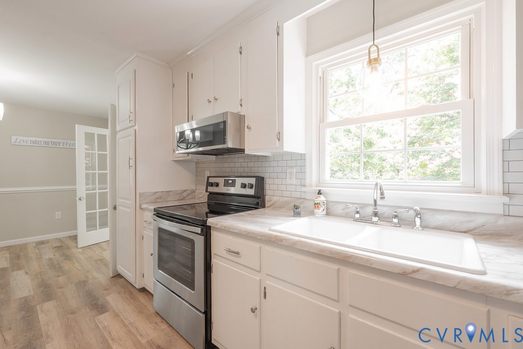 6901 Manning Road Chesterfield, VA 23832 - Photo 34 of 57 Bright kitchen featuring white cabinetry, a subway