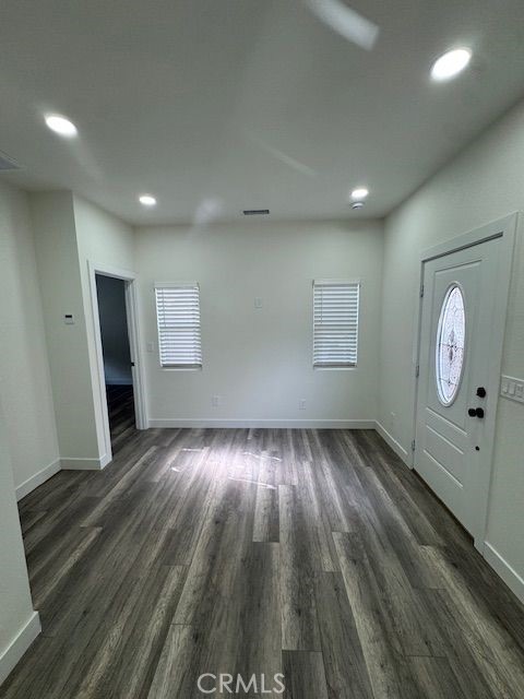4546 Big Sur Street, Unit 2 Oceanside, CA 92057 - Photo 5 of 10 an empty room with wooden floor and windows