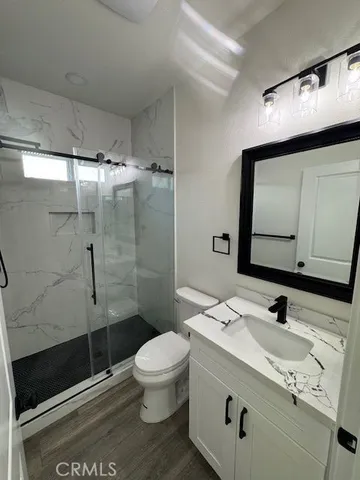 a bathroom with a sink toilet and shower