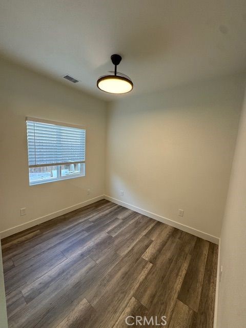 4546 Big Sur Street, Unit 2 Oceanside, CA 92057 - Photo 10 of 10 a view of a room with wooden floor and a ceiling fan