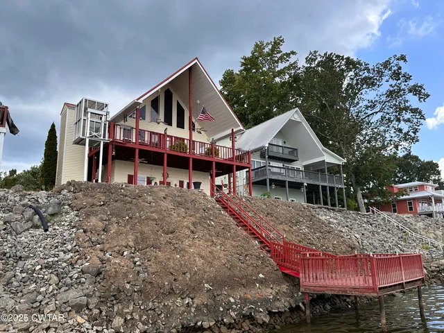 a view of a house with wooden fence