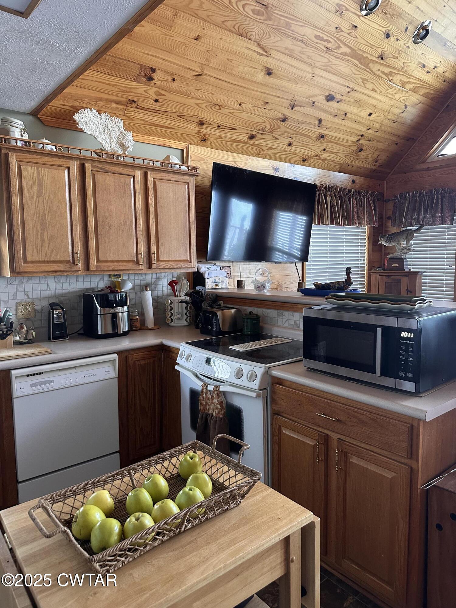 446 Miracle Road Decaturville, TN 38329 - Photo 13 of 22 a kitchen with a stove a sink and a microwave