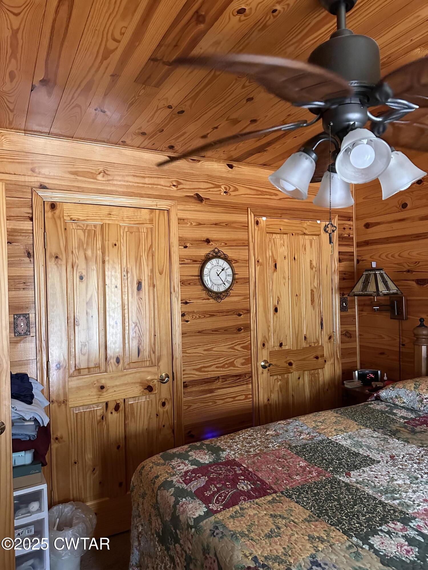 446 Miracle Road Decaturville, TN 38329 - Photo 16 of 22 a bedroom with a bed and a closet