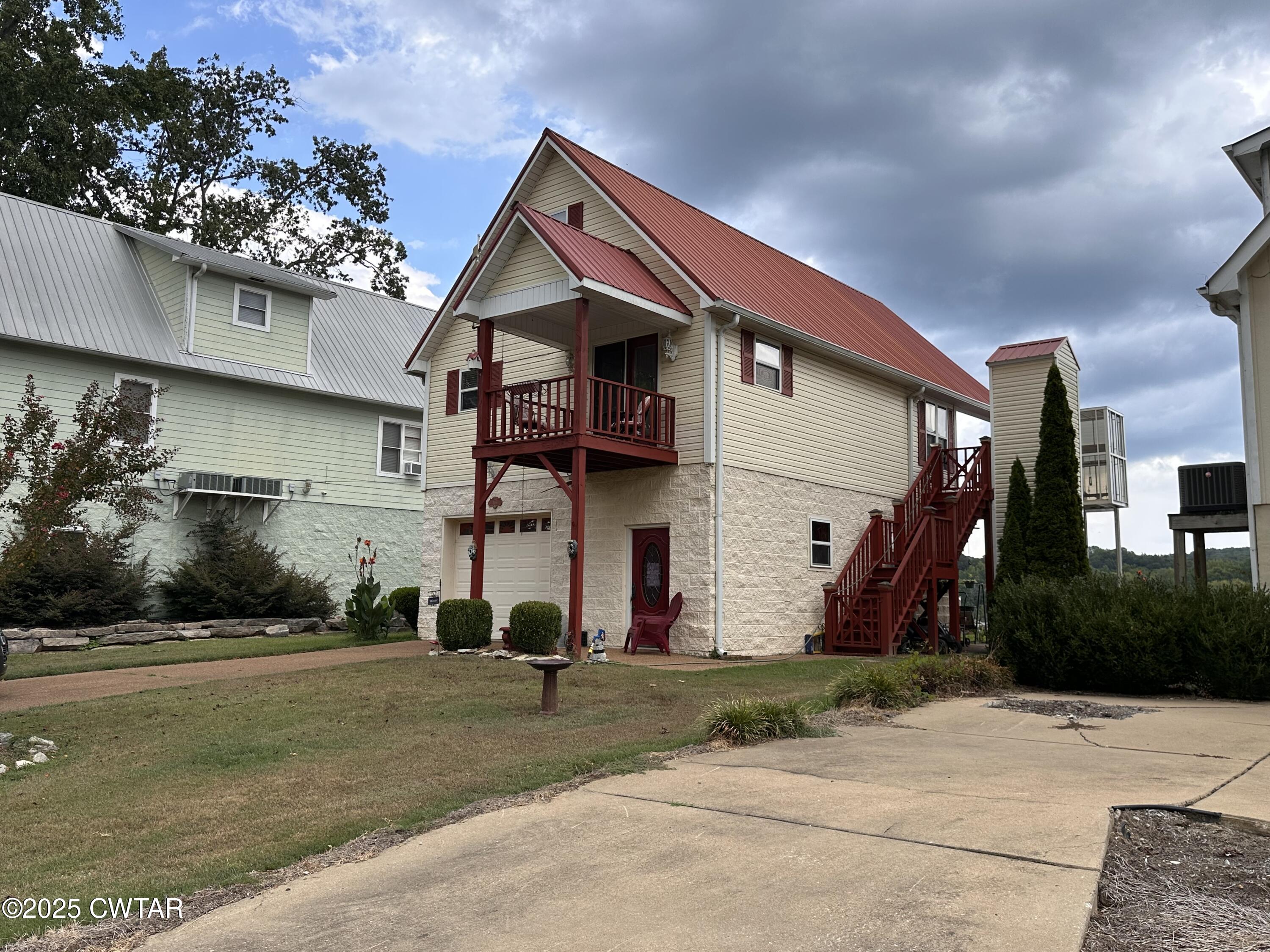 446 Miracle Road Decaturville, TN 38329 - Photo 2 of 22 a front view of a house with a yard