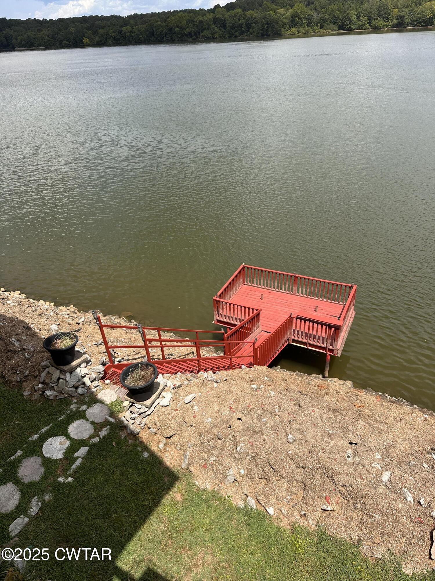 446 Miracle Road Decaturville, TN 38329 - Photo 4 of 22 a backyard of a house with table and chairs