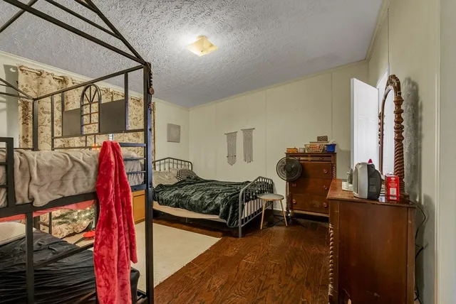 a bedroom with furniture and a flat screen tv