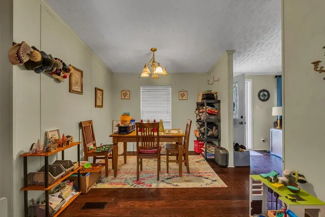 a view of a dining room with furniture and chandelier