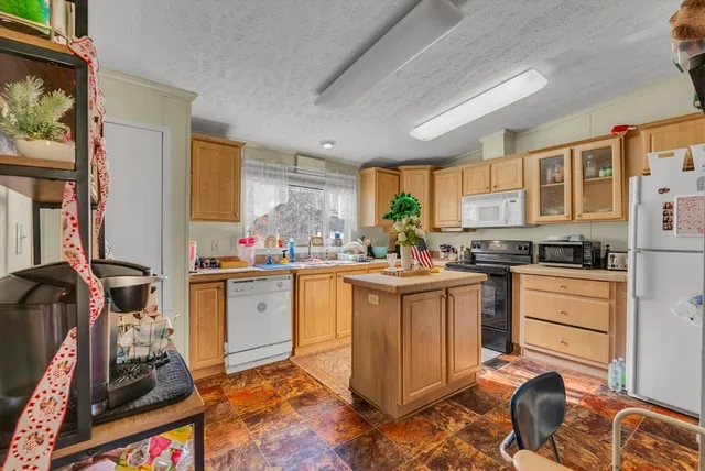 a kitchen with sink refrigerator and stove