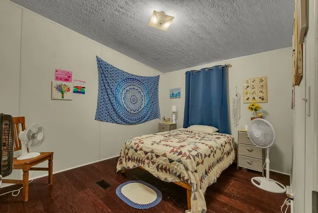 a bedroom with a bed and a table in it