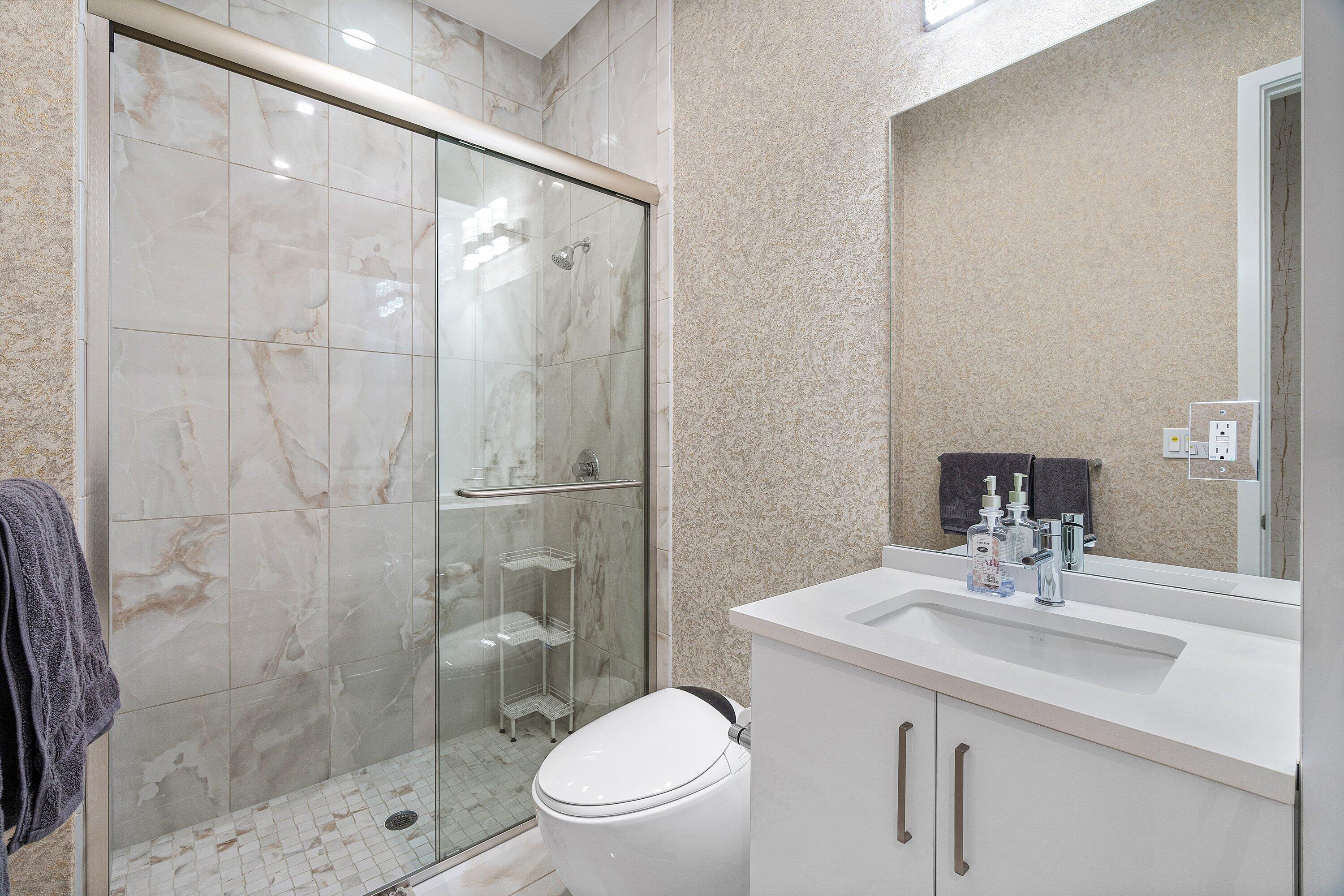 8233 Crystal Downs Avenue Boca Raton, FL 33434 - Photo 21 of 58 a bathroom with a sink toilet and shower