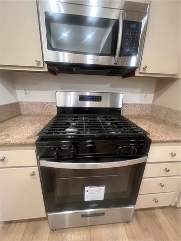 a stove top oven sitting inside of a kitchen