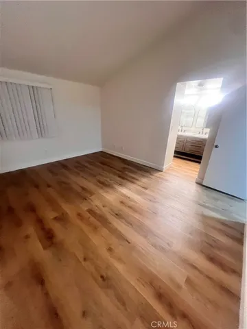 a view of an empty room and wooden floor