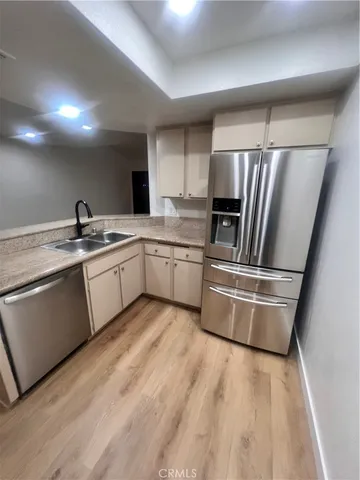 a kitchen with a sink stainless steel appliances and cabinets
