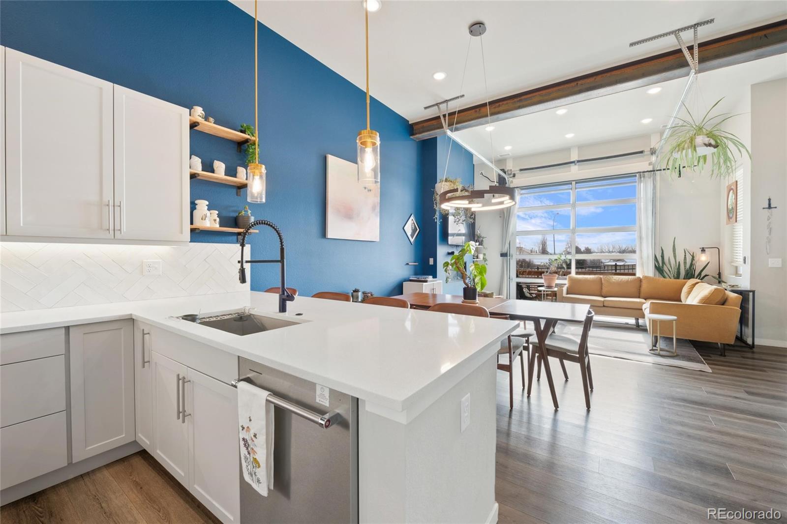 10105 Morrison Road Lakewood, CO 80227 - Photo 15 of 34 a kitchen with a table chairs and a white refrigerator