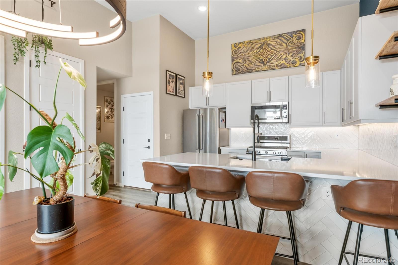 10105 Morrison Road Lakewood, CO 80227 - Photo 18 of 34 a dining room with furniture and a potted plant