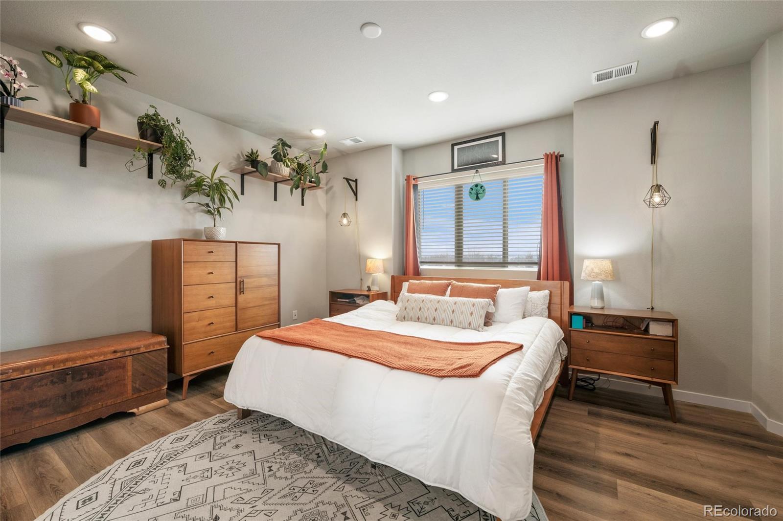 10105 Morrison Road Lakewood, CO 80227 - Photo 21 of 34 a bedroom with a bed and a dresser