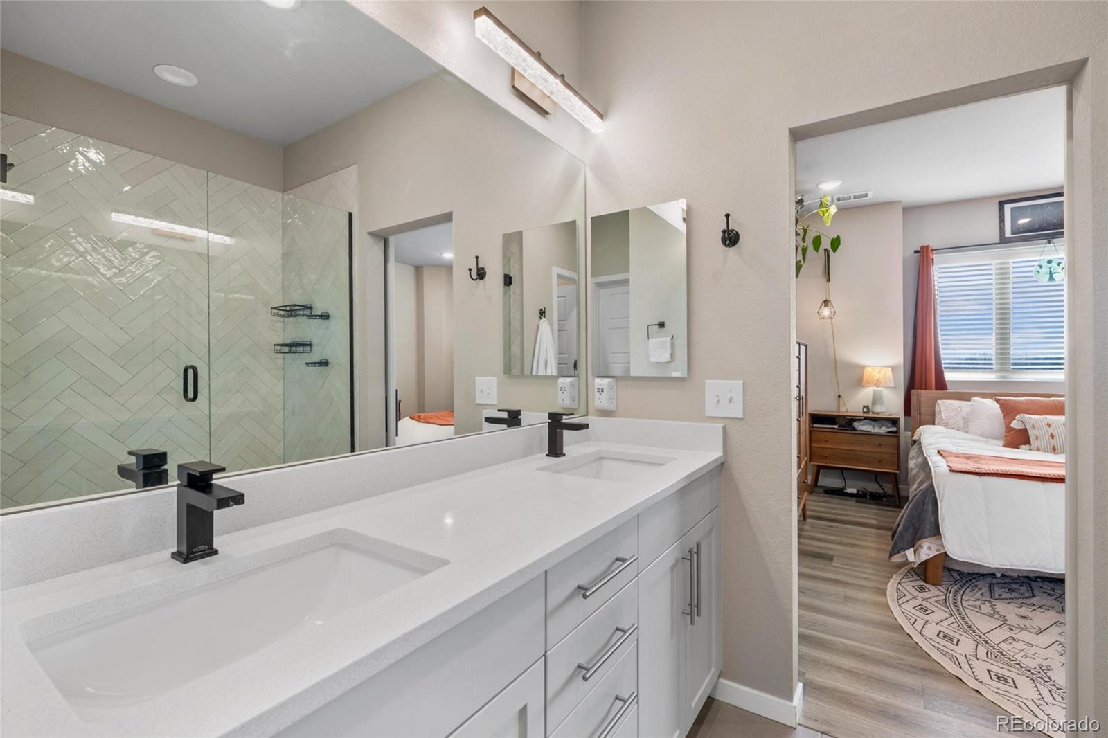 10105 Morrison Road Lakewood, CO 80227 - Photo 25 of 34 a bathroom with a sink double vanity and a mirror