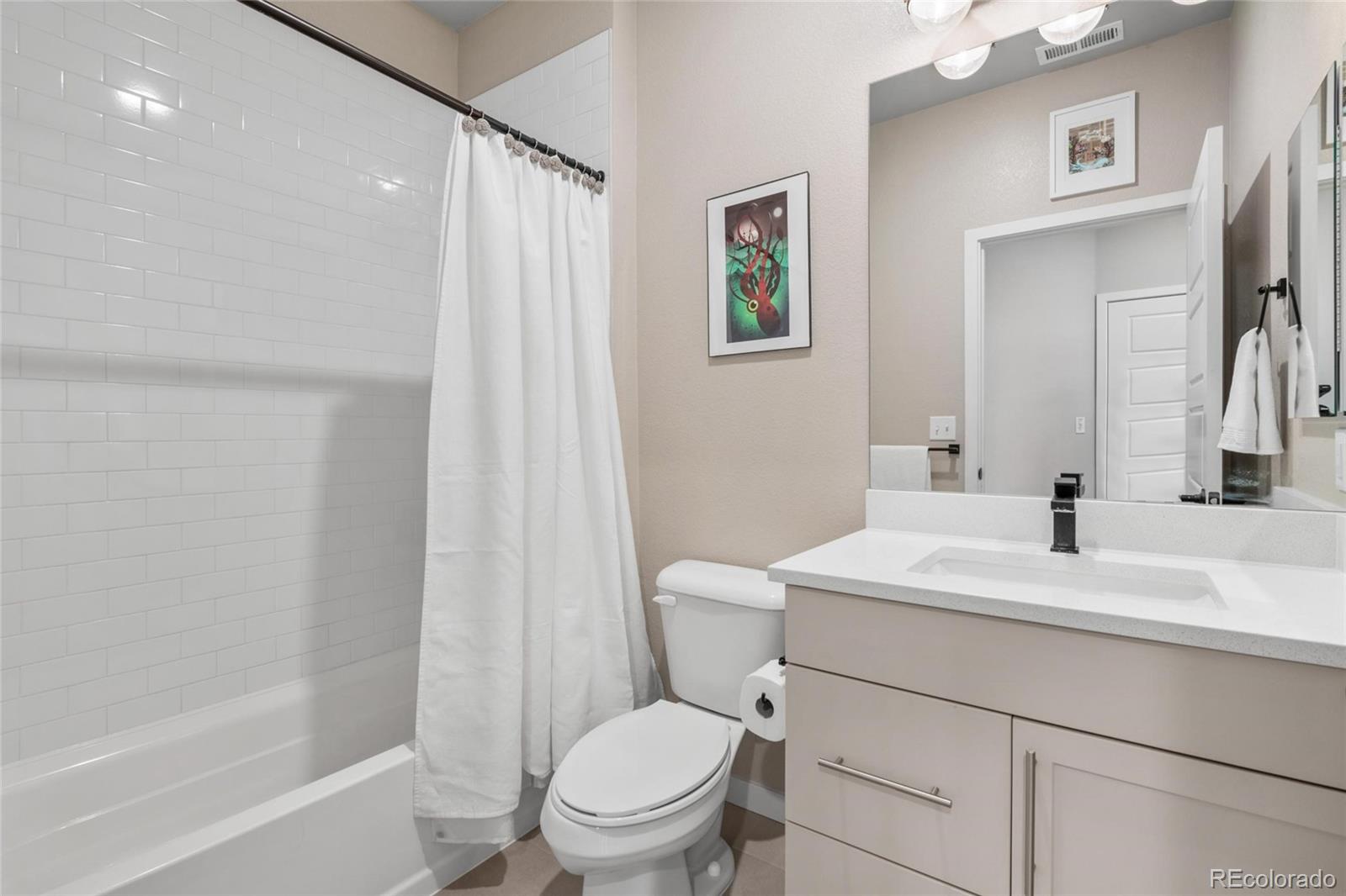10105 Morrison Road Lakewood, CO 80227 - Photo 30 of 34 a bathroom with a sink a toilet and shower