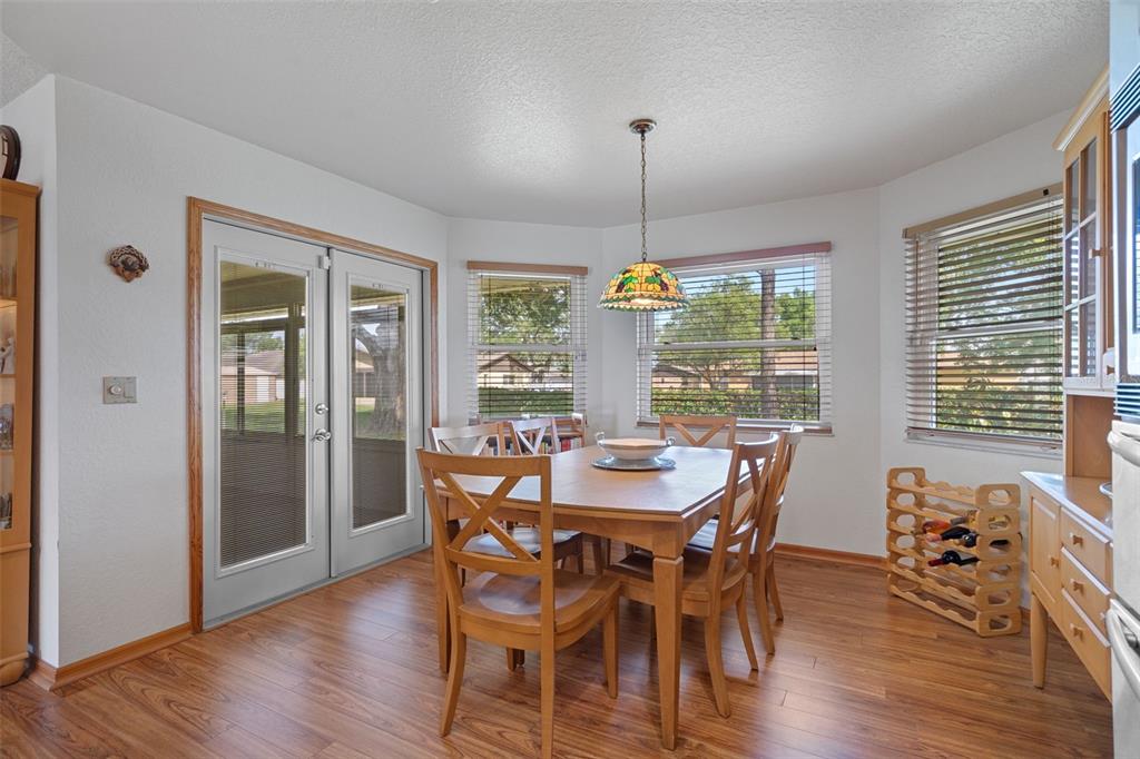 5035 Harbinger Road Spring Hill, FL 34608 - Photo 26 of 47 a view of a dining room with furniture window and wooden floor