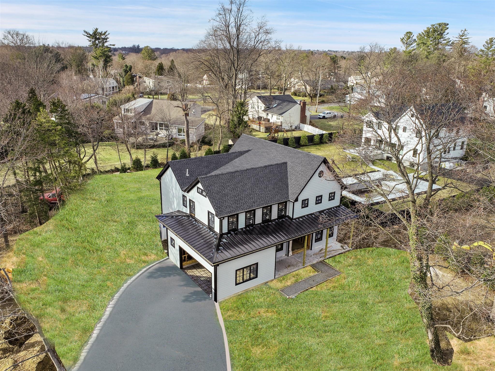 an aerial view of a house with a big yard