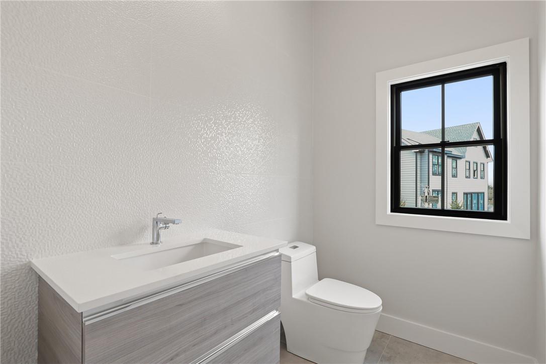 345 Betsy Brown Road Rye Brook, NY 10573 - Photo 11 of 34 a white toilet sitting next to a bathroom sink