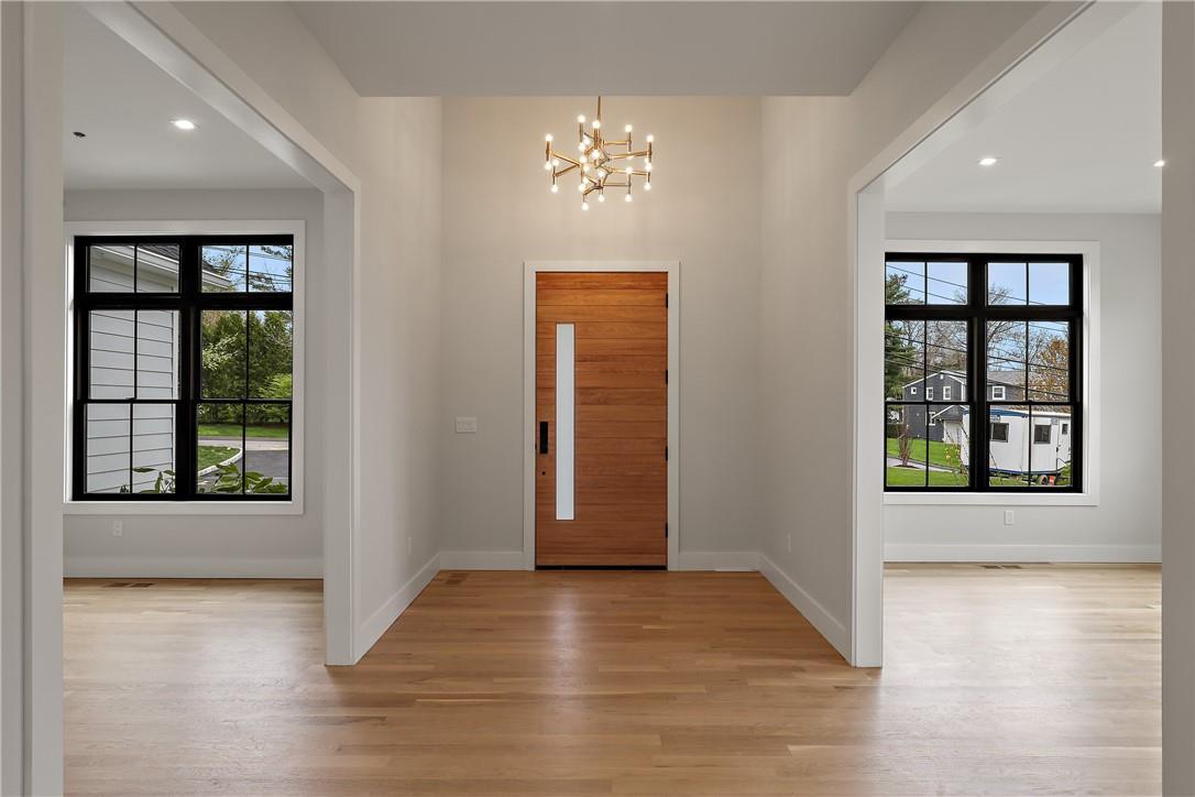 345 Betsy Brown Road Rye Brook, NY 10573 - Photo 14 of 34 an empty room with wooden floor and windows