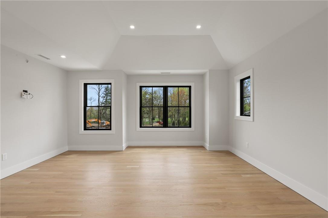 345 Betsy Brown Road Rye Brook, NY 10573 - Photo 15 of 34 wooden floor in an empty room with a window