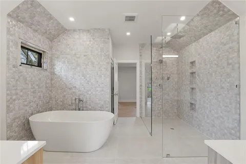 a bathroom with a bathtub and shower