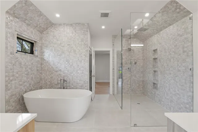 a bathroom with a bathtub and shower
