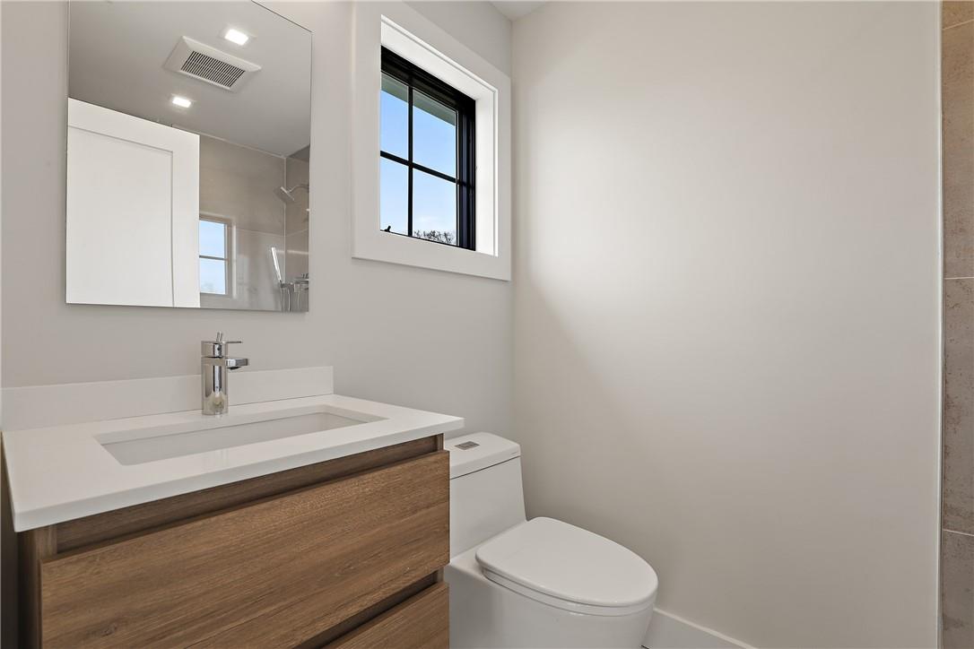 345 Betsy Brown Road Rye Brook, NY 10573 - Photo 20 of 34 a bathroom with a sink a toilet and mirror
