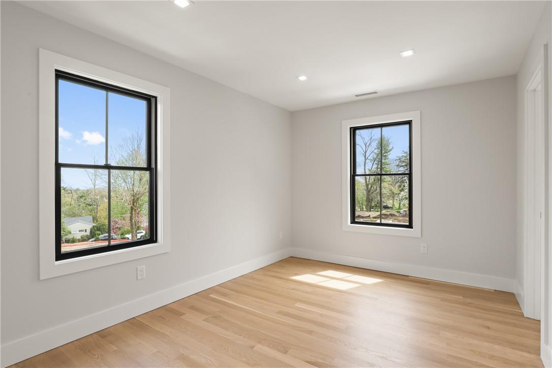 345 Betsy Brown Road Rye Brook, NY 10573 - Photo 23 of 34 an empty room with windows