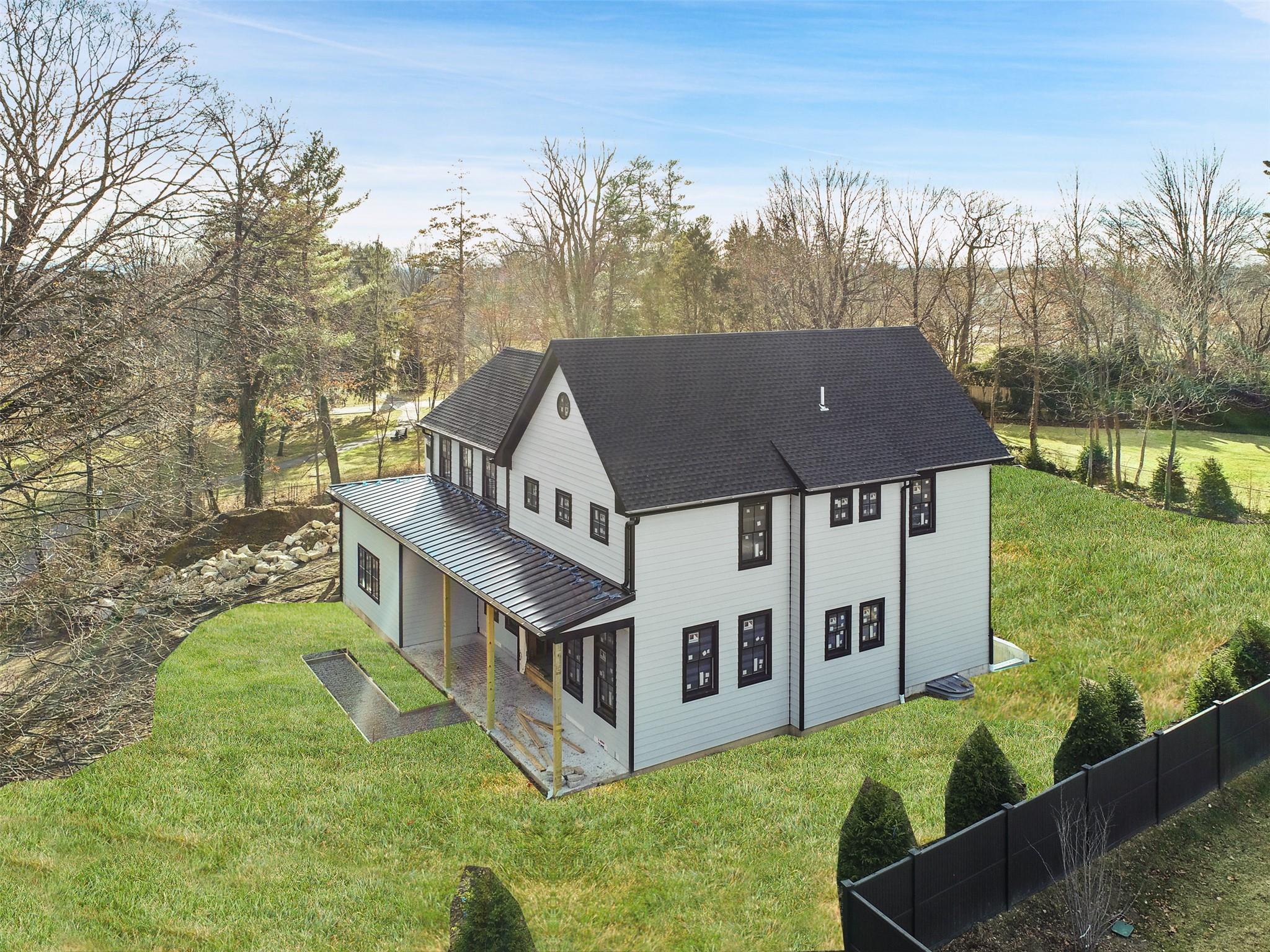 345 Betsy Brown Road Rye Brook, NY 10573 - Photo 4 of 34 a aerial view of a house with a big yard and large trees
