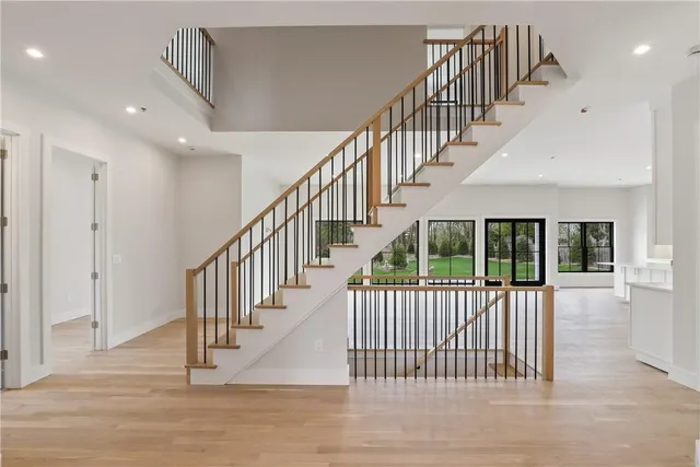 a view of staircase with lots of frames and white walls