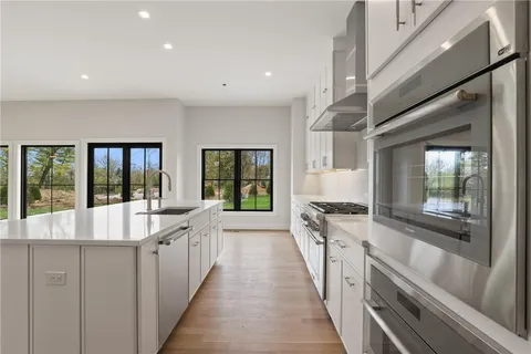 a large kitchen with stainless steel appliances granite countertop a large counter top and a stove
