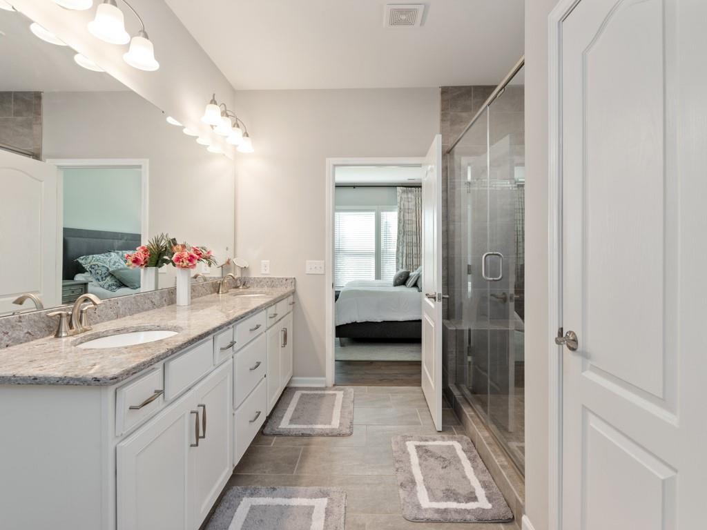 5292 Sweet Fig Way Fort Mill, SC 29715 - Photo 17 of 36 a spacious en suite bathroom with a double vanity sink and a mirror