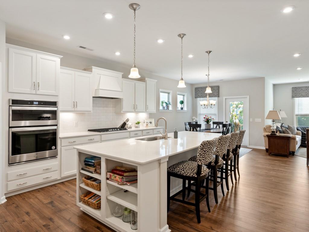 5292 Sweet Fig Way Fort Mill, SC 29715 - Photo 2 of 36 a large kitchen with kitchen island a dining table and chairs