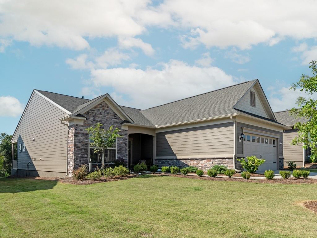 5292 Sweet Fig Way Fort Mill, SC 29715 - Photo 24 of 36 a front view of a house with a garden and trees