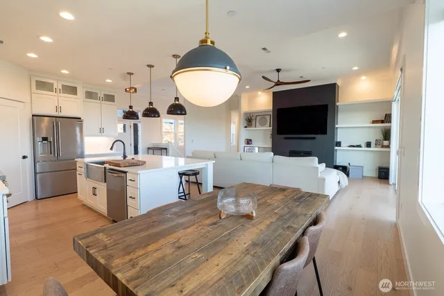 a large kitchen with stainless steel appliances granite countertop a stove a sink and a microwave