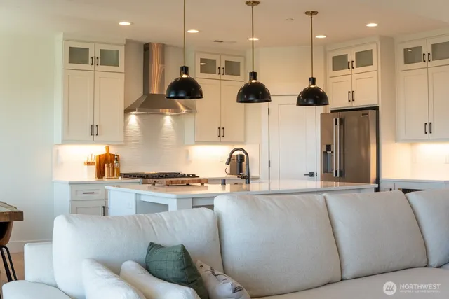 a living room with stainless steel appliances kitchen island granite countertop furniture and a view of kitchen
