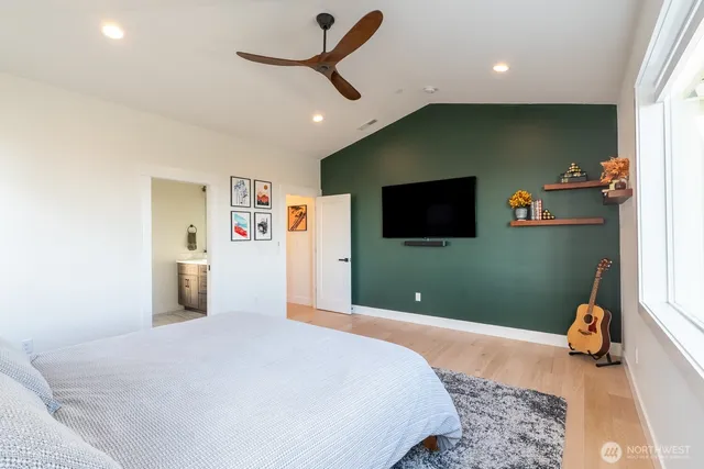 a bedroom with a bed and a flat screen tv