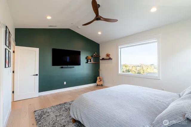 a bedroom with a bed and a flat screen tv